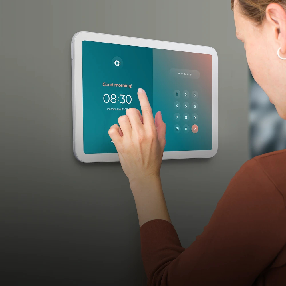 A woman clock in her time entries on a wall-mount ipad