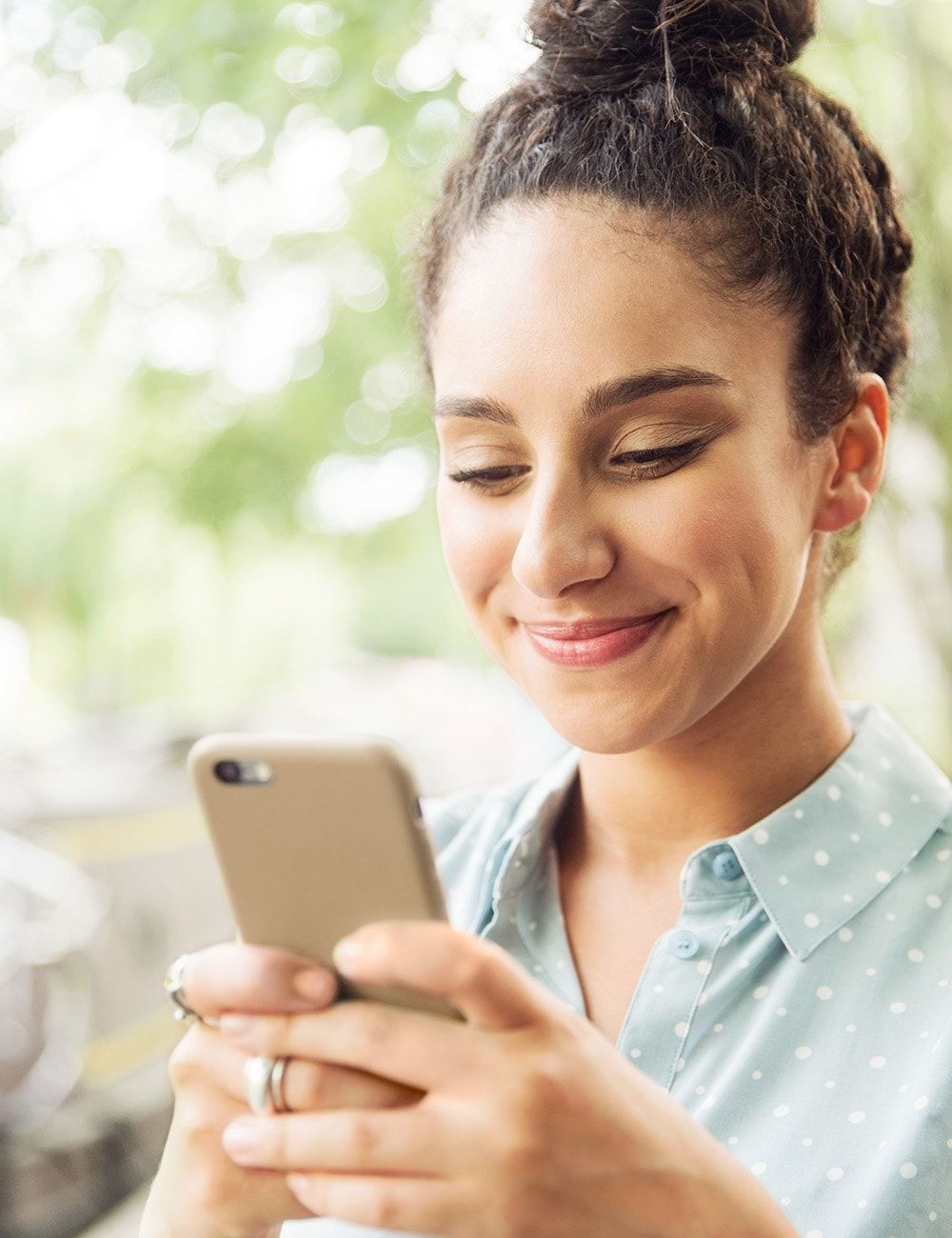 Woman looking at cell phone and smiling