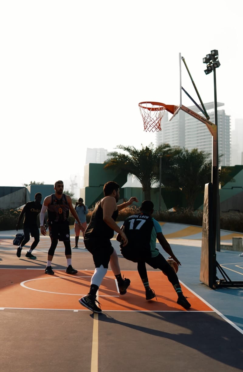 Young men playing basketball outside