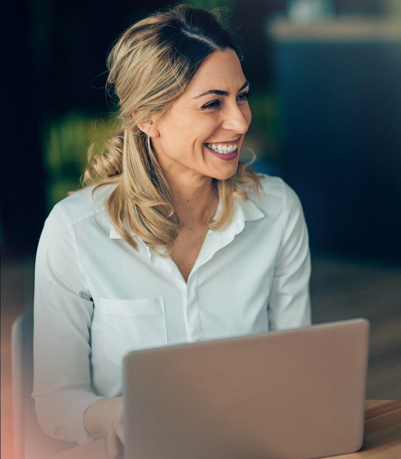 Young girl smiling and managing payroll on a computer software