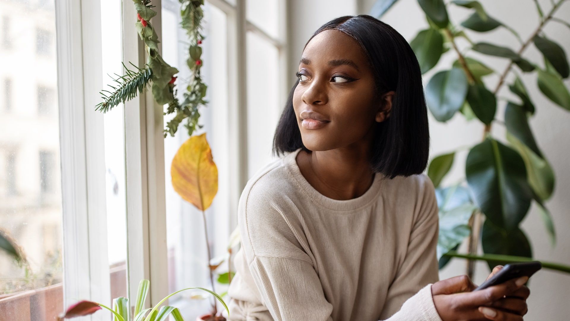Jeune fille qui crée fait la gestion d'horaire via l'app Agendrix sur son cell. Elle regarde sur la gauche