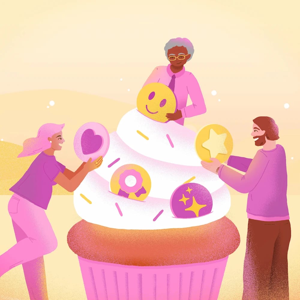 Three people decorate a cupcake icing with a smiley face, star, heart and other elements.