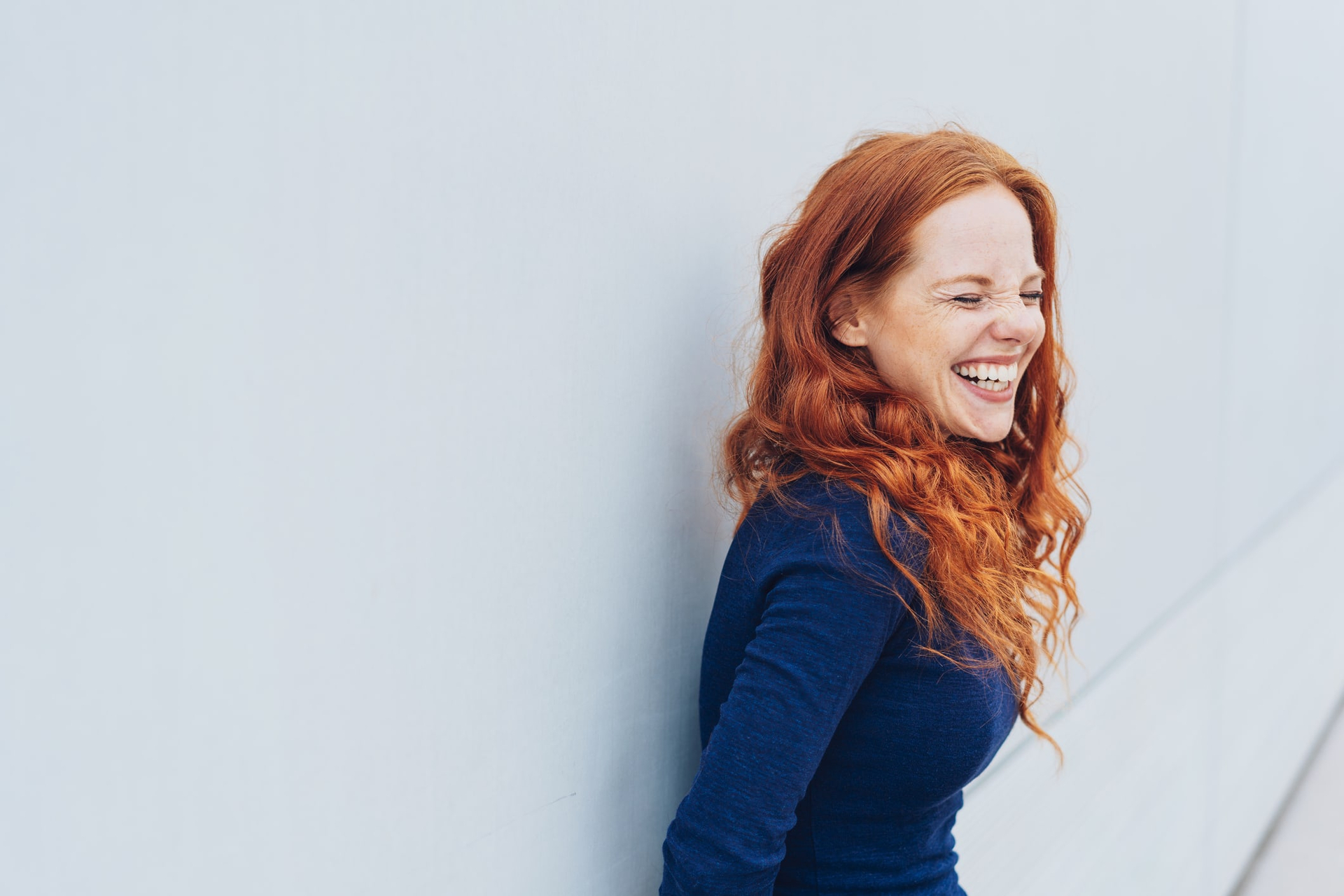Woman with red hair laughing