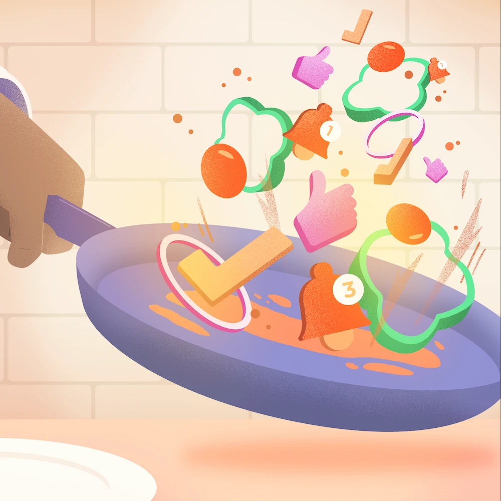 main qui tient une poêle et qui fait sauter des légumes