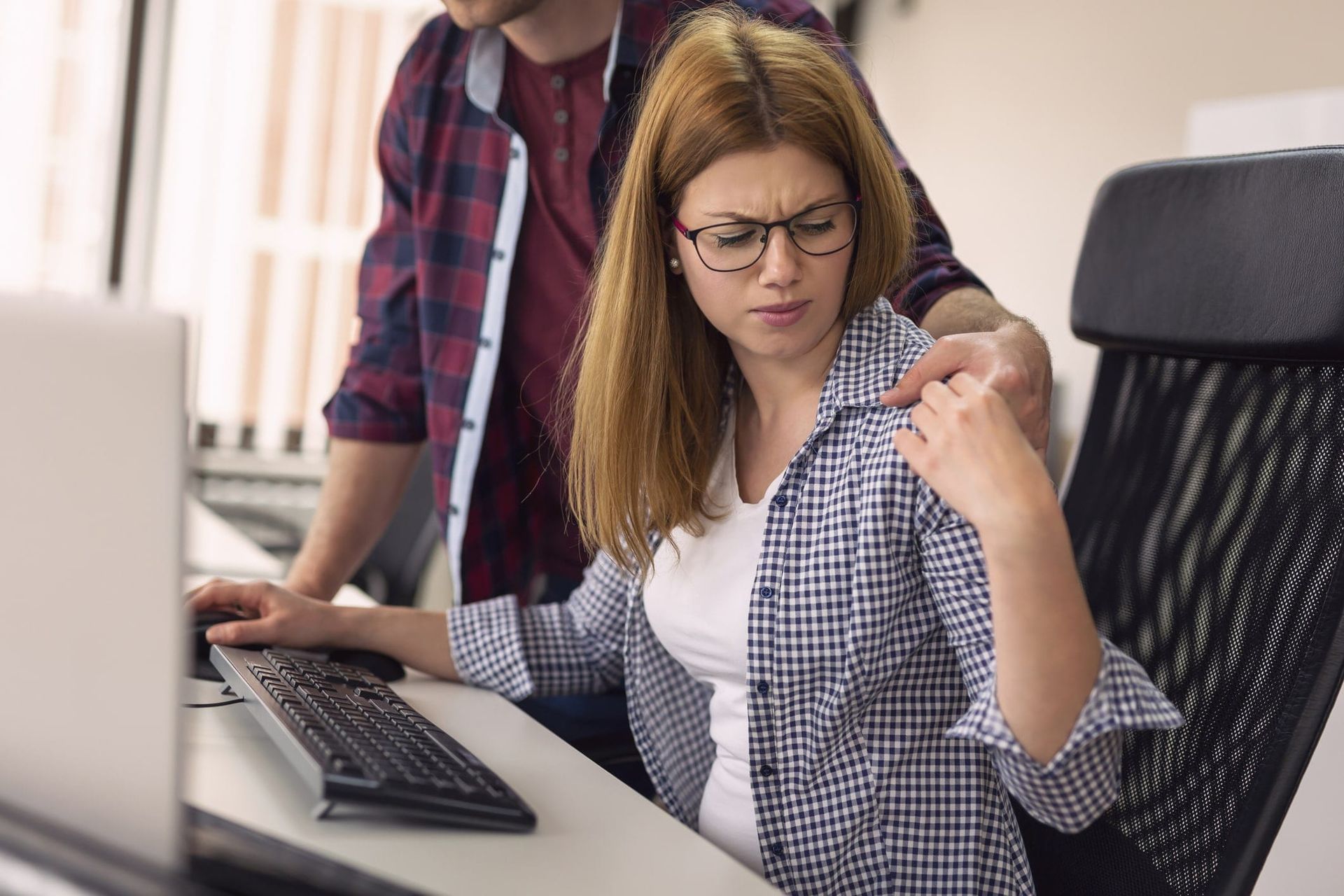 Young man hugging inappropriately his coworker