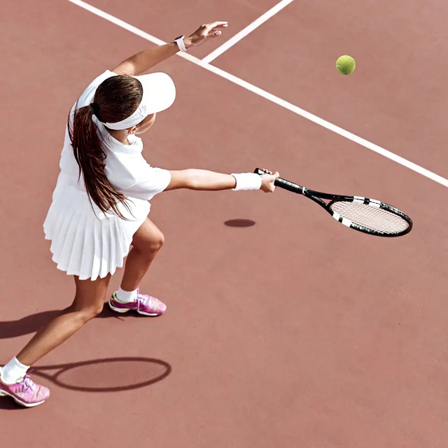 Woman seen from above playing tennis.