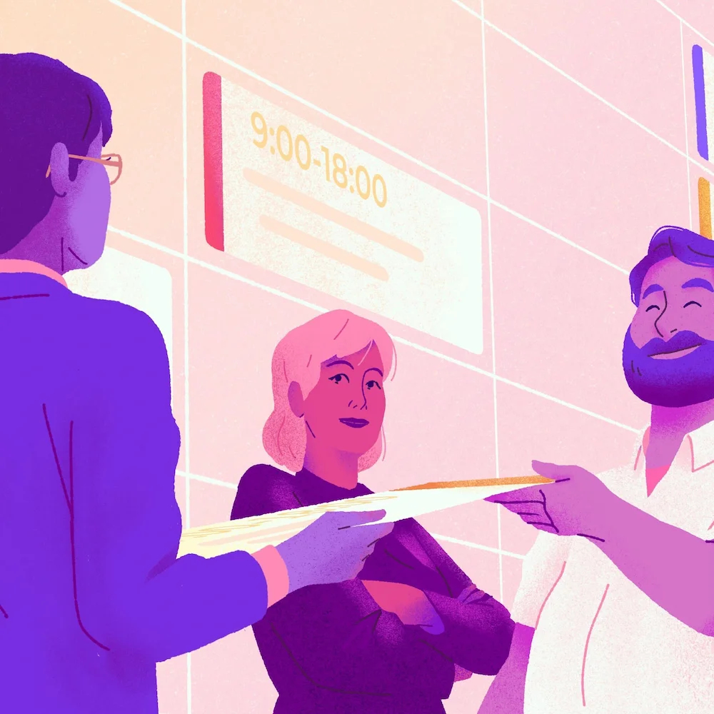 Une femme remet un papier à un homme barbu qui est debout à côté d'une autre femme et d'un horaire mural.